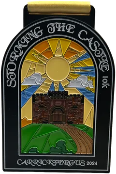 Black arched coloured base metal medal with gold ribbon, Storming the Castle 10k Carrickfergus