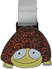 Bespoke glitter enamel tortoise medal with orange glitter shell and a white ribbon