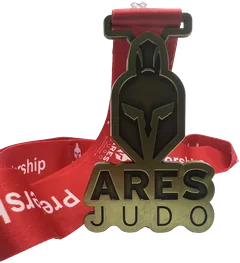 Antique bronze non enamel Ares Judo medal with a spartan helmet design and a red ribbon