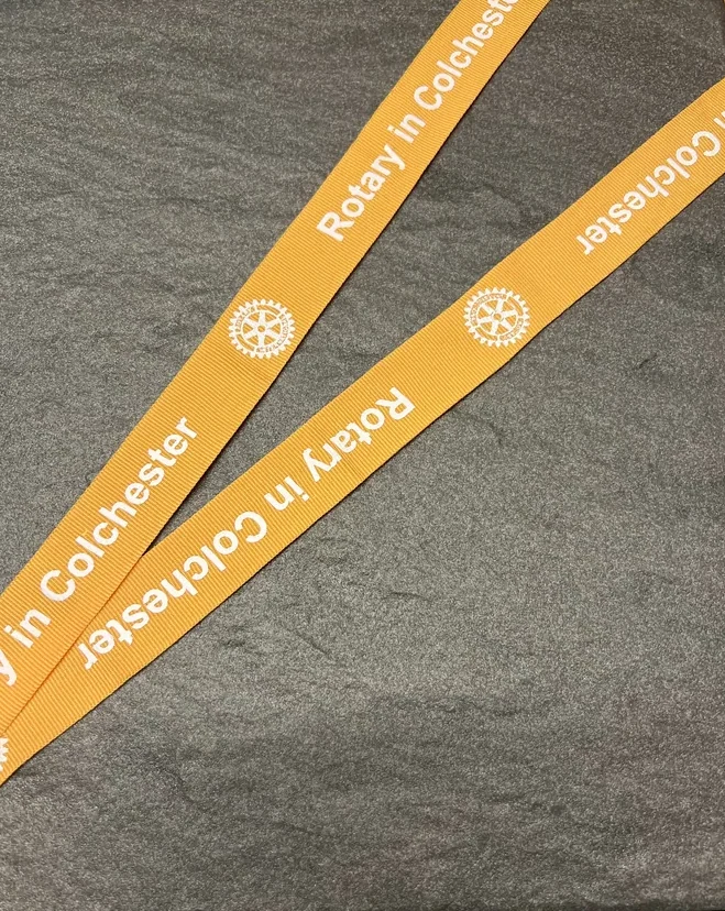 Rotary in Colchester printed on a gold woven ribbon