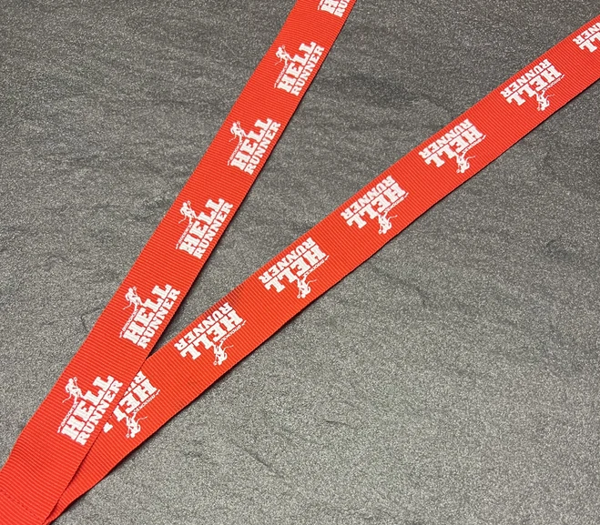 HELL RUNNER printed in white on a red woven ribbon