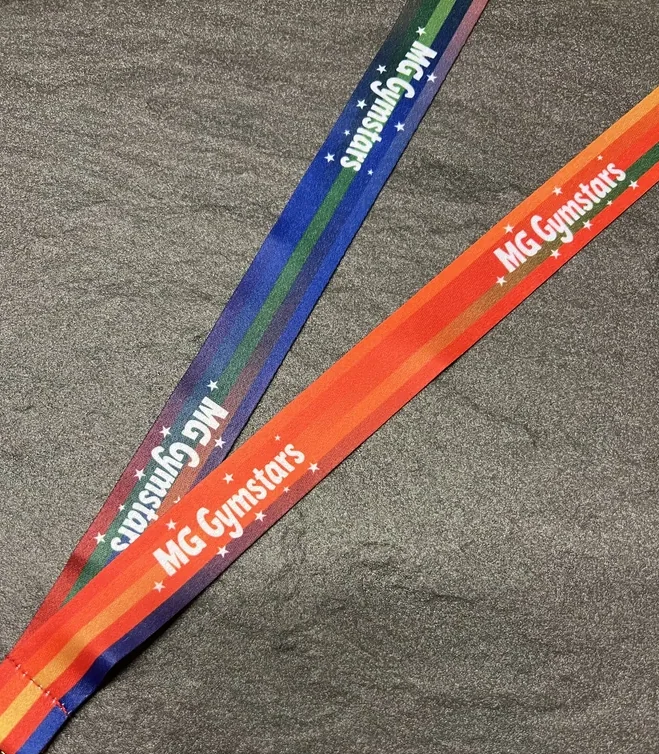 MG Gymstars on a multi colour red, orange, blue and green sublimation ribbon